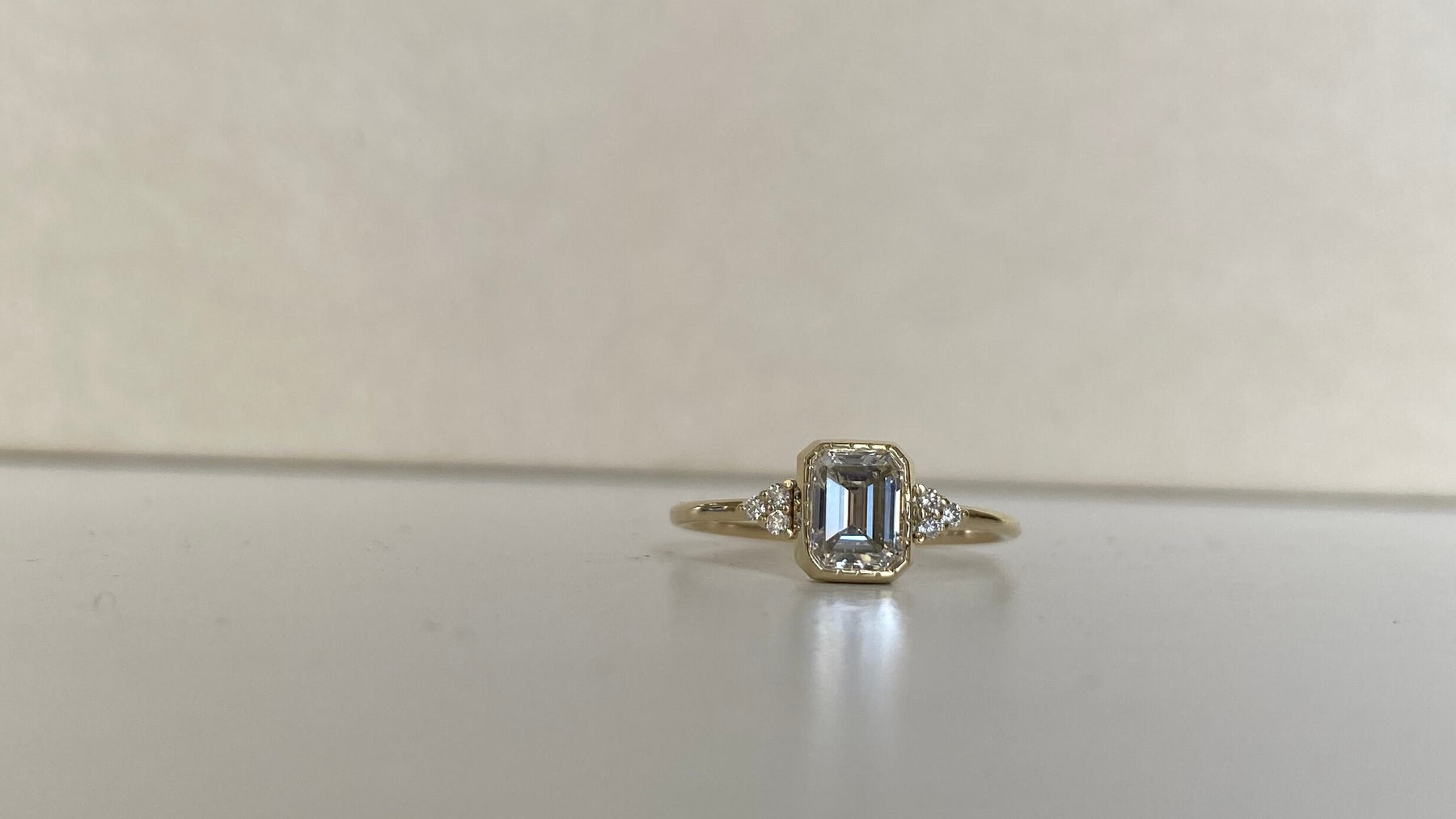 14k yellow gold custom engagement ring with princess cut white diamond center stone and white diamond side stones