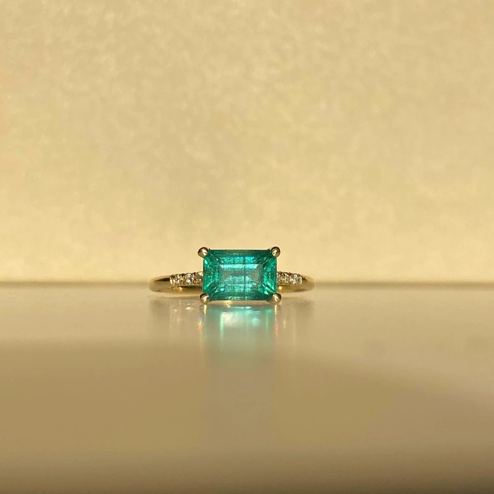 14k yellow gold custom ring with princess cut emerald center stone