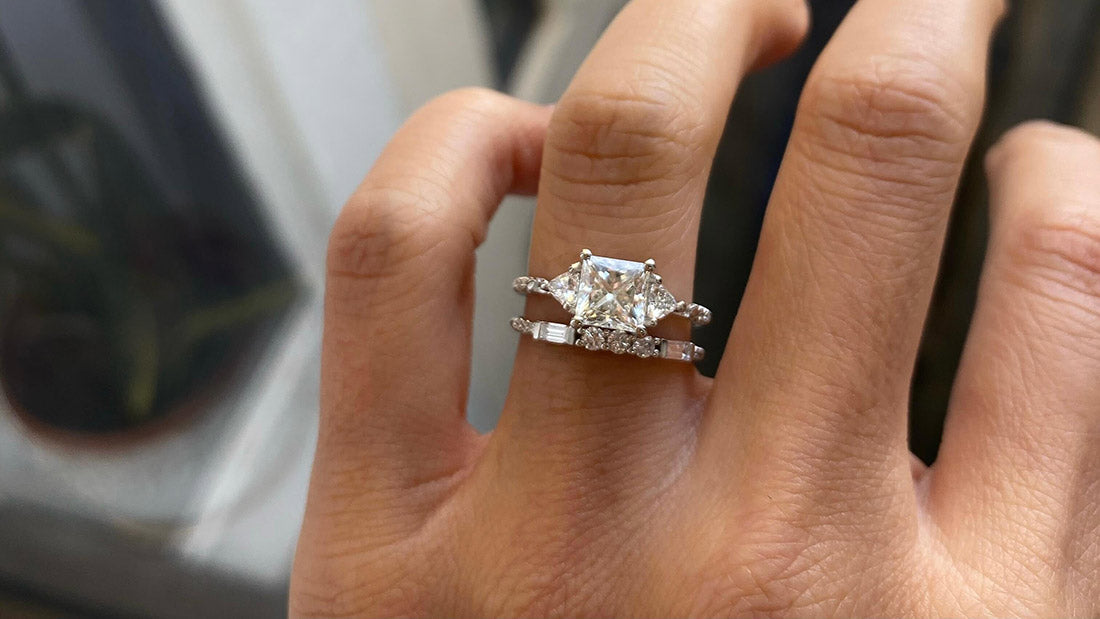14k yellow gold custom engagement ring with square white diamond center stone stacked with white diamond float ring on hand