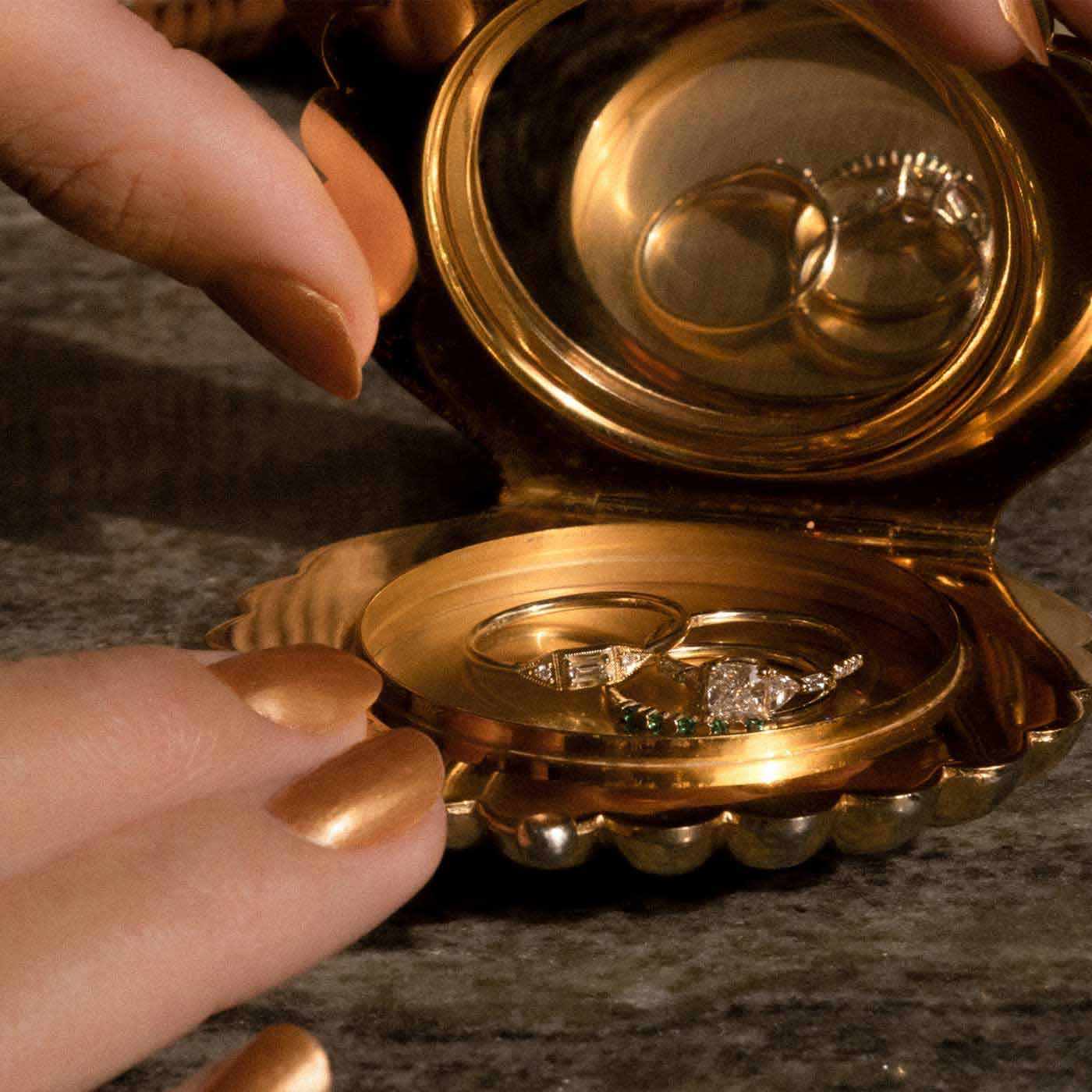 Hands and Rings in Gold Dish