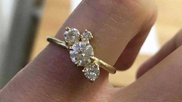 14k yellow gold custom ring with cluster of 4 white diamonds on hand