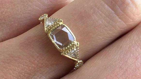 14k yellow gold custom ring with square white diamonds and milgrain detail and side white diamonds on hand
