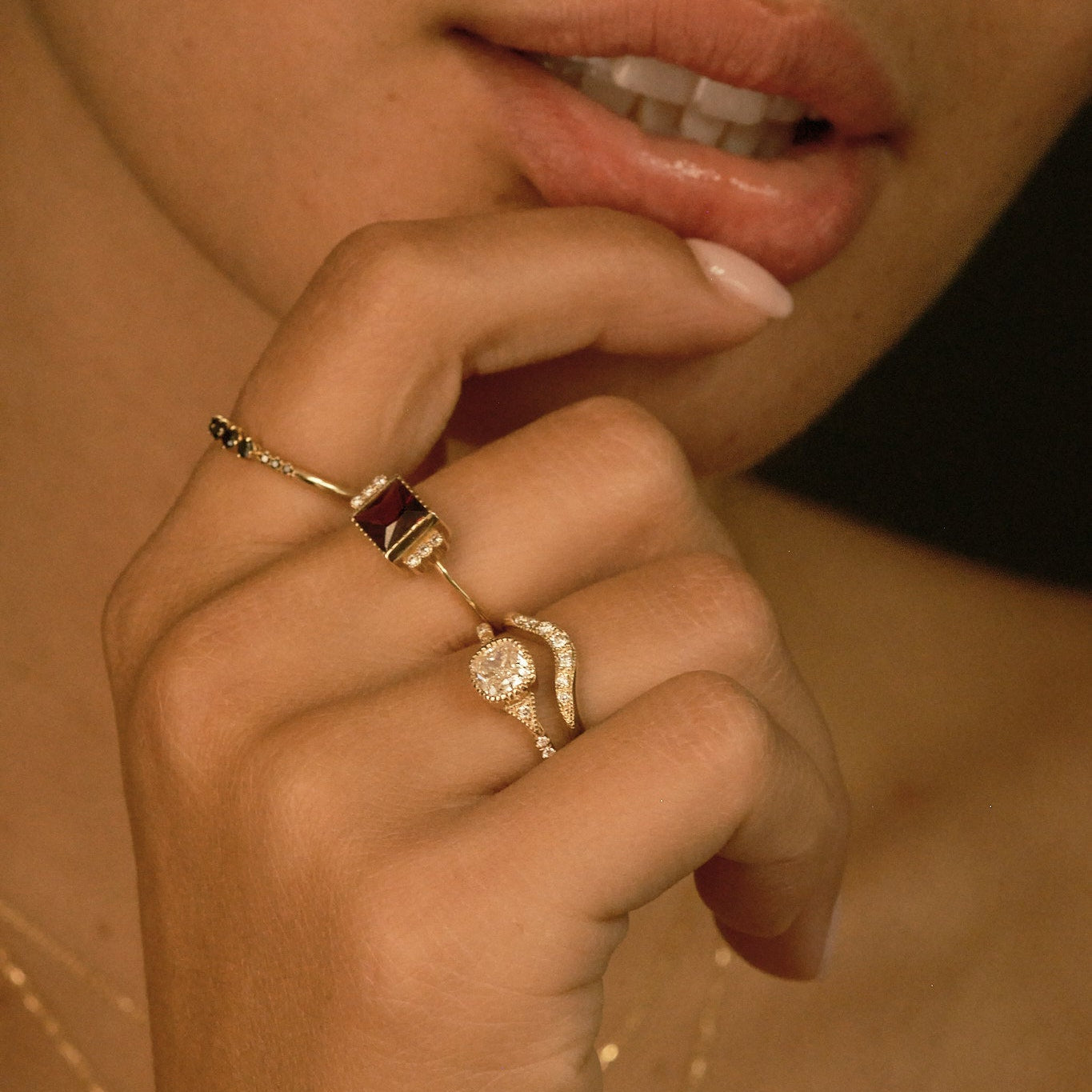 Close-up of a person's hand with rings, focusing on jewelry.