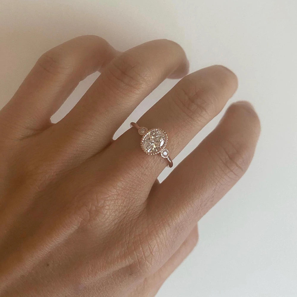 14k yellow gold engagement ring with white diamond center stone and side diamonds