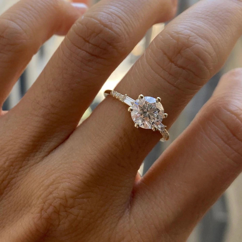 14k yellow gold custom engagement ring with round cut white diamond center stone and pave white diamonds on hand