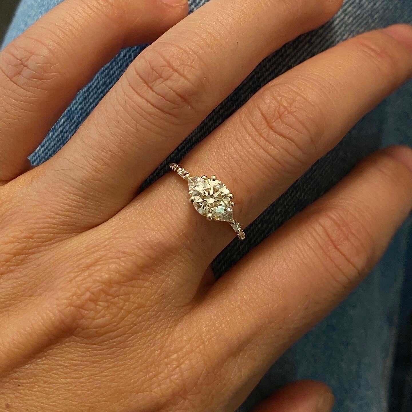 14k yellow gold custom engagement ring with marquise cut white diamond center stone and pave white diamonds