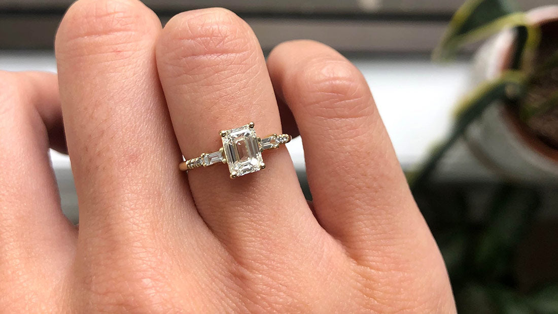 14k yellow gold custom engagement ring with princess cut white diamond and pave white diamonds on hand