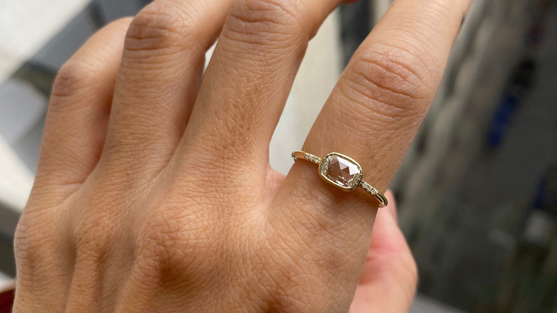14k yellow gold custom ring with square white diamond center stone and pave white diamond equilibrium side stones
