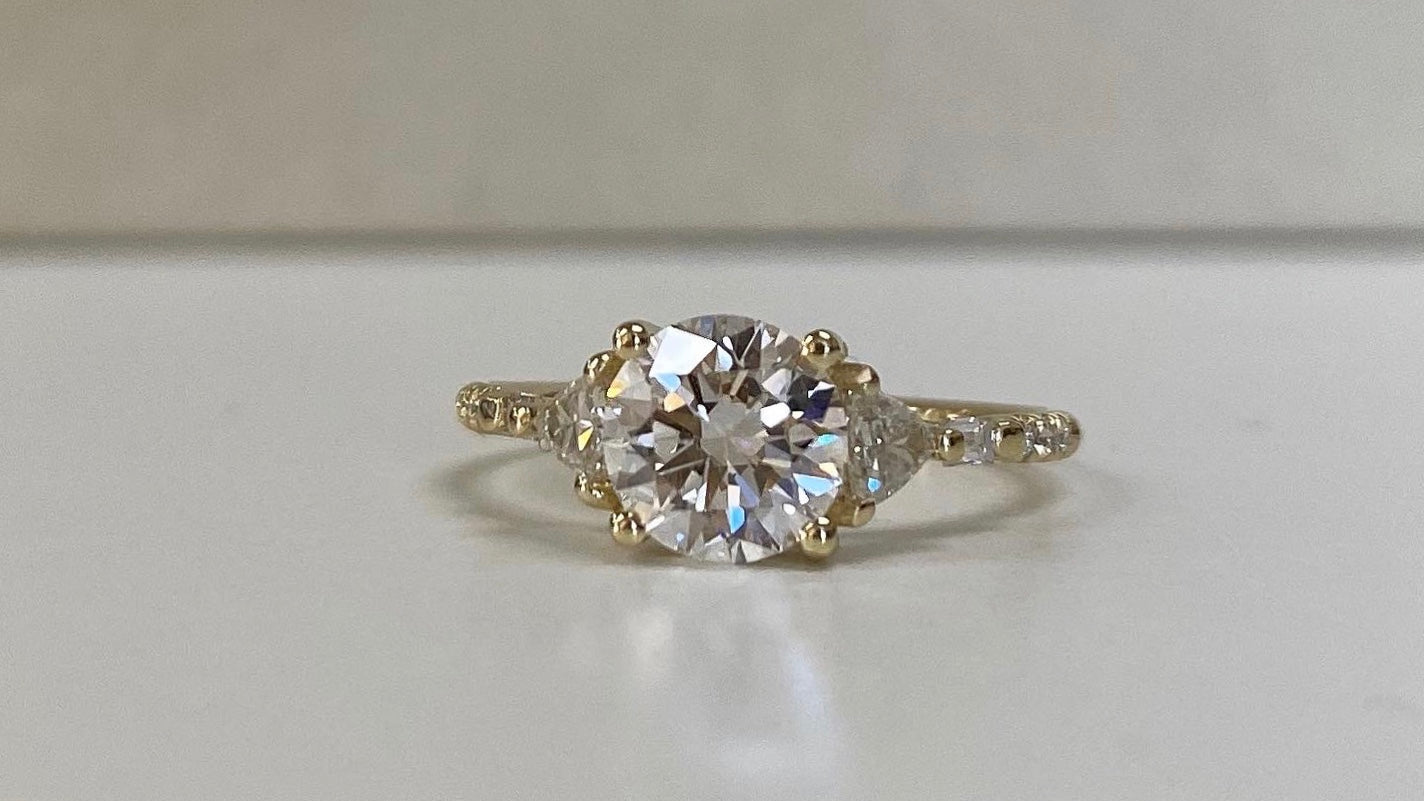14k yellow gold custom engagement ring with white diamond round cut center stone and pave white diamonds