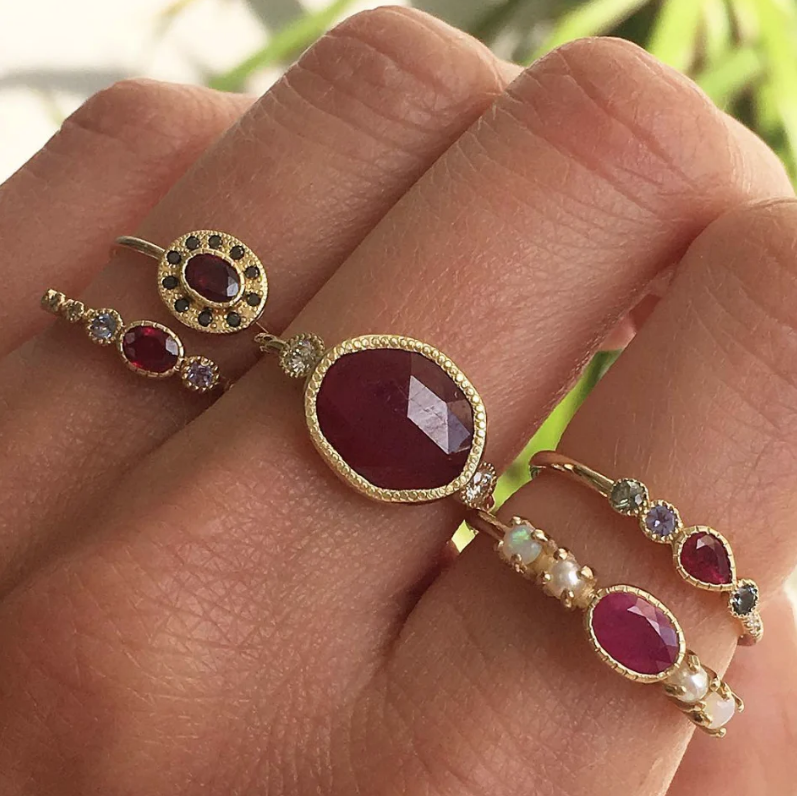 Ruby and Gold Rings stacked on model hand