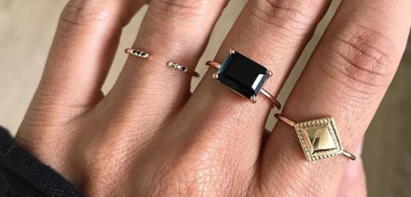 From left: Black Equilibrium Cuff Gold Ring, East West Onyx Gold Ring, Square Milli Gold Ring