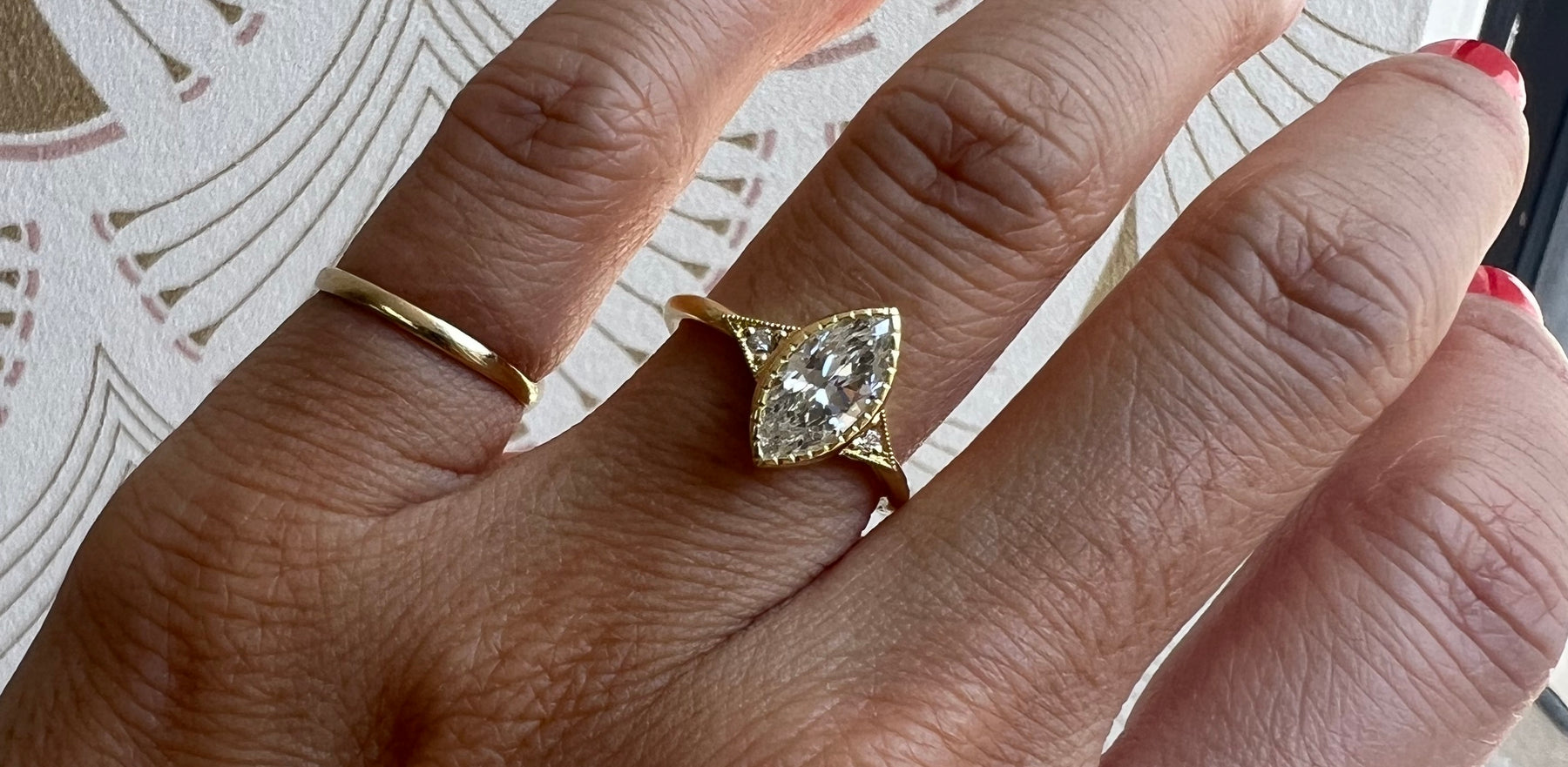 14k yellow gold custom engagement ring with marquise white diamond center stone and deco diamond triangles