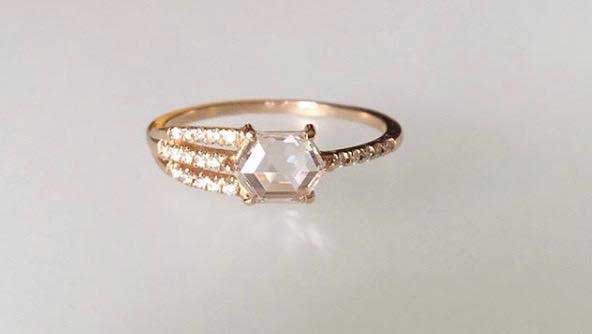 14k yellow gold custom engagement ring with hexagonal white diamond center stone and four bands of pave white diamonds