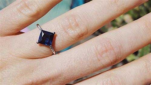 14k yellow gold custom ring with square cut blue sapphire and white diamond pave on hand 