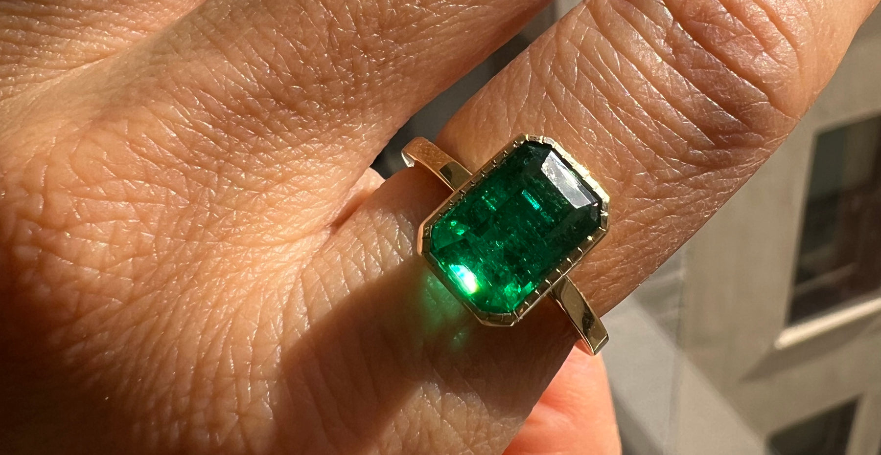 14k yellow gold custom engagement ring with emerald cut emerald