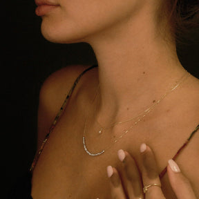 Close-up of a woman's profile with jewelry on a dark background