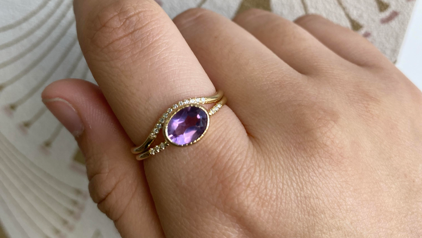 14k yellow gold custom wave ring with oval amethyst center stone and pave diamonds
