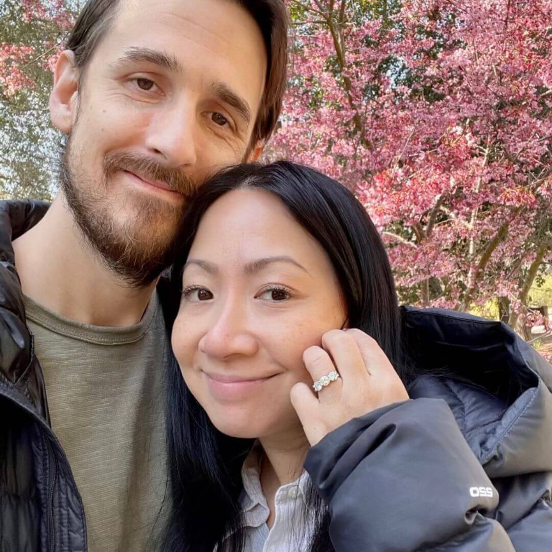 couple wearing engagement ring