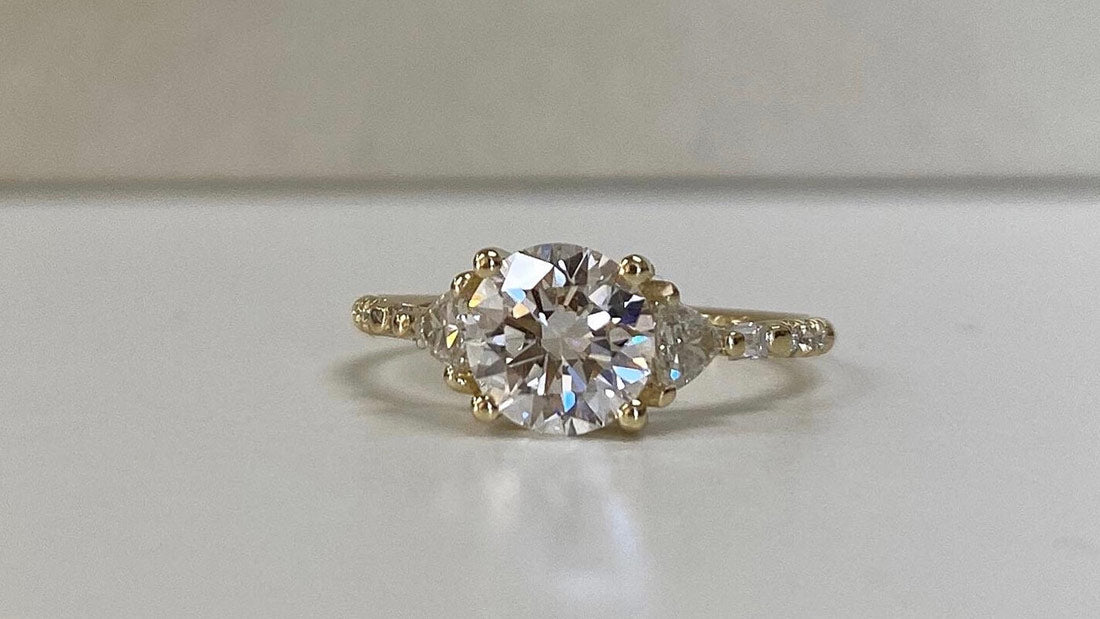 14k yellow gold custom engagement ring with white diamond round cut center stone and pave white diamonds